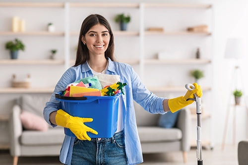 A Cleaner carrying the tools needed to clean your home
